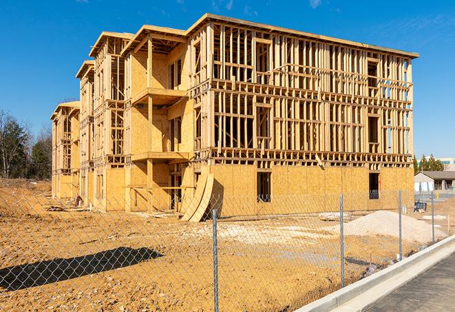 a close-up of temporary chain link fences enclosing a job site, signaling progress in the project's development in Stockton